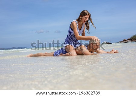 Happy funny couple in retro swimsuit on the beach