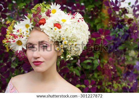 Beauty Nature Model Girl with Flowers Hair. Perfect Hairstyle. Bouquet of Beautiful Flowers. Natural Cosmetics