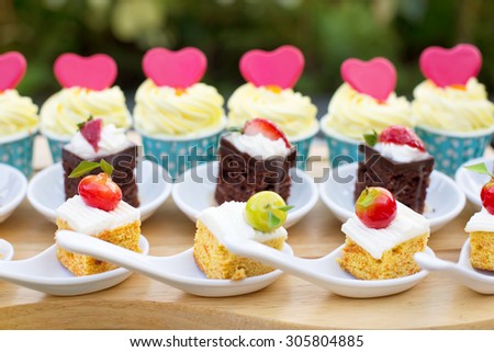 Luxury Sweet Buffet Dessert for Holiday with pink Love Hearts on small Cakes Outdoor
