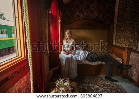 Just Married Bride and Groom Sitting in Luxury Train. Wedding and Honeymoon Travel