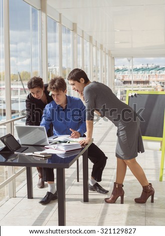 Business team emotionally discussing problems in office. Businessman and female employee looking at laptop monitor. Economic Crisis, unexpected expenses, bad news