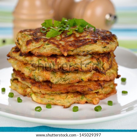 Zucchini pancakes close-up on a white plate