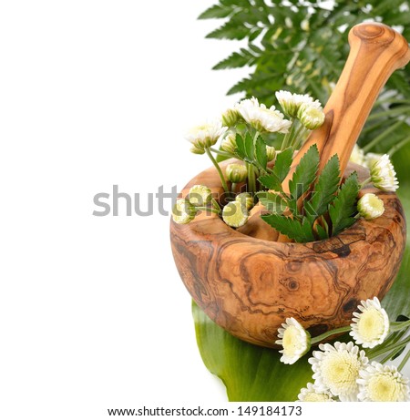Wooden mortar and flowers on a white background