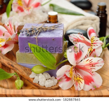 Soap and flowers on a brown background