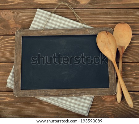 Writing board and spoon on brown background