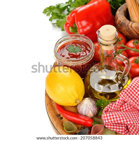 Olive oil, vegetables and spices on a white background