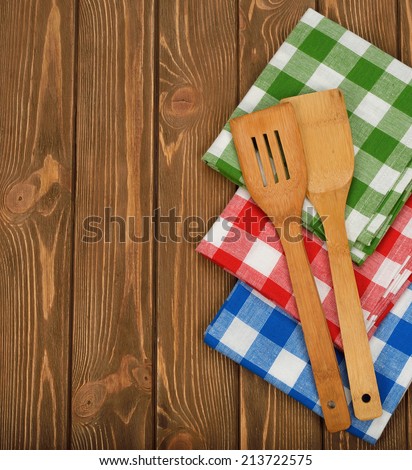 Wooden spoon and napkin on a brown background
