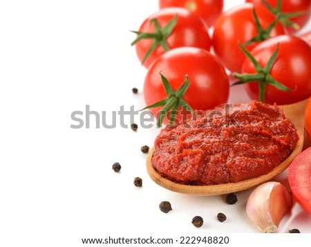 tomato paste in wooden spoon on  white background