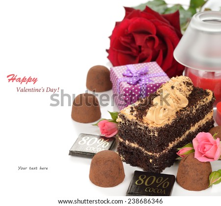 Piece of cake with chocolate truffles on a white background