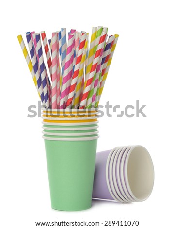 Multicolored retro straws in a paper cup, isolated on white background