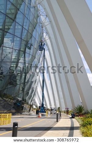 SINGAPORE - JULY 29_Workers cleaning windows of the Flower Dome at Gardens by the Bay in Singapore on July 29, 2015.