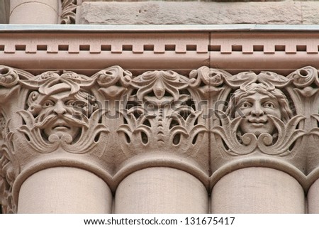 happy and sad face carvings, Old City Hall, Toronto