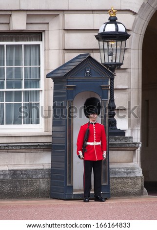LONDON - AUGUST 7, 2013:  One of the royal palace guards, who are famous for standing without moving for long periods of time, as seen at Buckingham Palace in London on August 7, 2013.