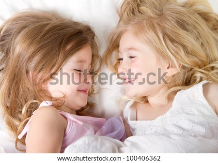 Preschool age girls in bed having a sleep-over