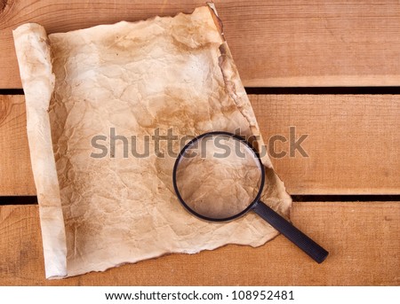 Blank map with magnifying glass on a plank