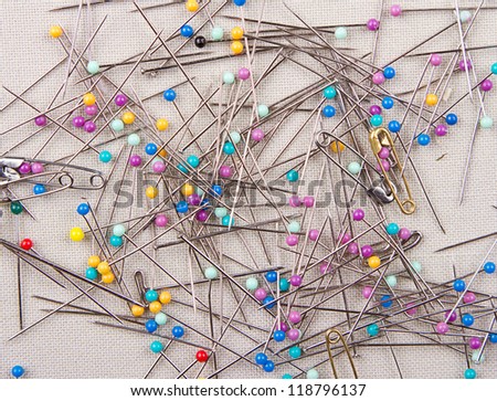 Sewing pins multicolored on a piece of fabric