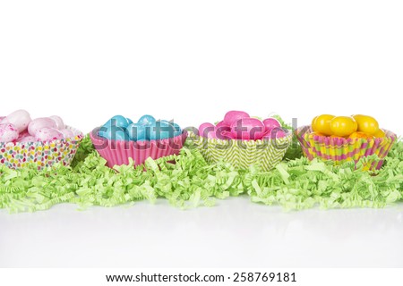 Easter Candy in colorful cupcake wrappers with green confetti