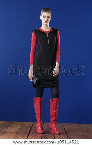 full body fashion woman in purse posing wooden floor in studio