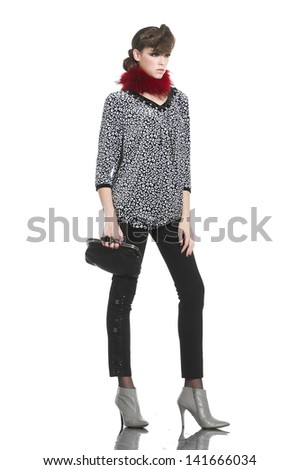 fashion style young woman holding purse with scarf posing in studio