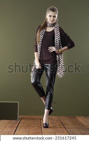 full body fashion woman in fashion dress with cube posing wooden floor on dark background