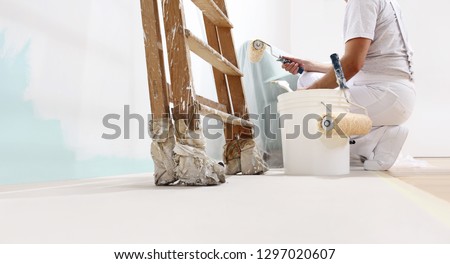 painter man at work with a roller, bucket and scale, from below view, copy space template Stock fotó © 