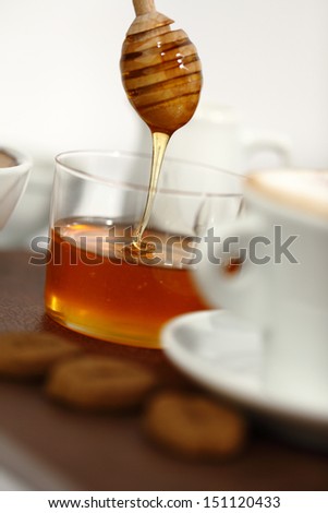 honey with a cup of coffee and cookies