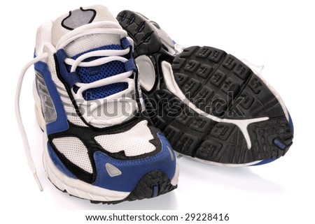 A pair of running shoes, all logos and markings removed. Studio shot on white, not isolated