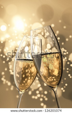 stock-photo-an-image-of-two-champagne-glasses-on-light-bokeh-background-126201074.jpg