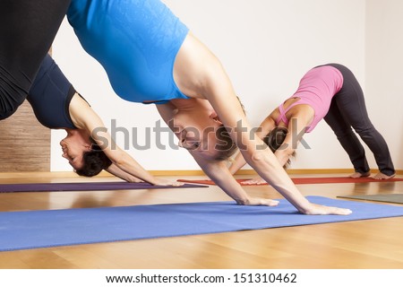 An image of some people doing yoga exercises