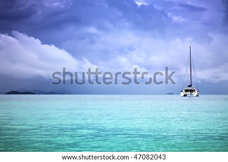 A photography of a catamaran in the ocean and overcast sky