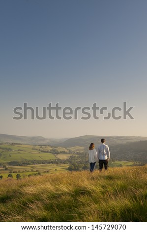 couple looking over a valley to hills beyond