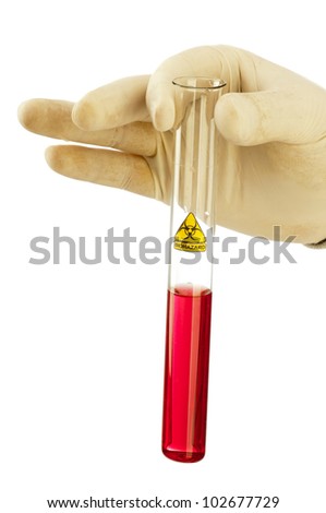 Hand holds glass tube with red fluid and symbol biohazard