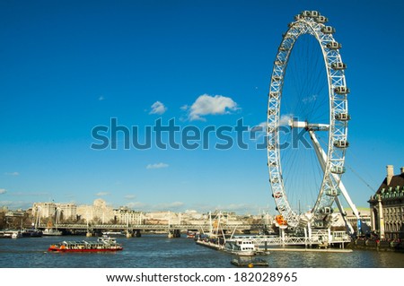 LONDON, UNITED KINGDOM - FEBRUARY 16, 2014: London eye park amusement with blue sky on Thames river on February 16, 2014, UK