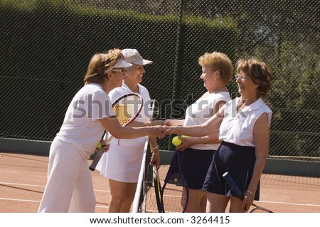 Senior women shaking hand after tennis match