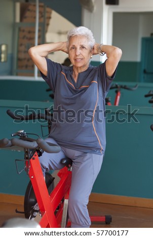 Senior woman exercising on a spinning bicycle