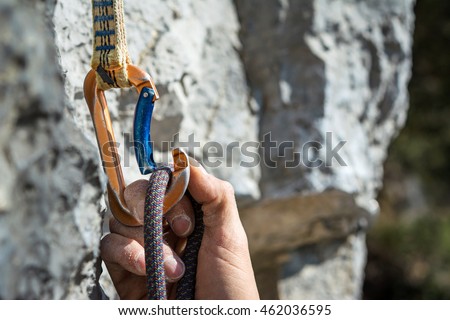 Similar – Foto Bild Detail der Kletterausrüstung, die an einem Klettergurt einer Frau befestigt ist, während sie eine Route klettert