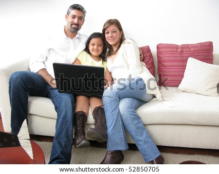 Parents whit son look in notebook on white background