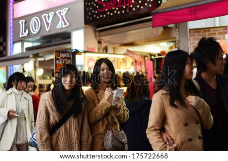 TOKYO, JAPAN - NOV 24 : Crowd at Takeshita street Harajuku on November 24, 2013 in Tokyo, Japan. Takeshita street is a street lined with fashion, cafes and restaurants in Harajuku.