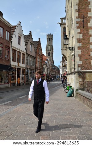 Bruges, Belgium - May 11, 2015: Belgian people in Bruges city on May 11, 2015. The historic city centre is a prominent World Heritage Site of UNESCO.