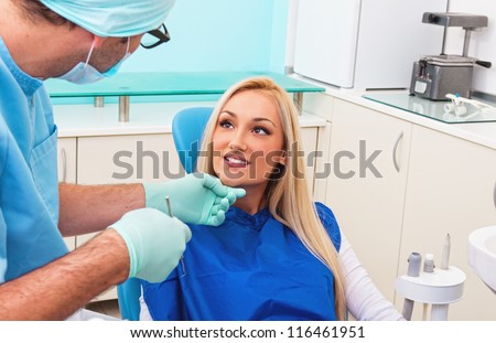 Dentist and his patient talking in examination room