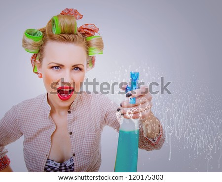 Funny housewife / woman spraying the cleaner on you. Glass or window cleaner, foam / soap on glass