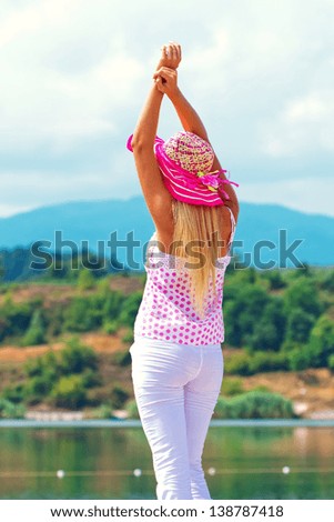 Pretty young woman with arms up