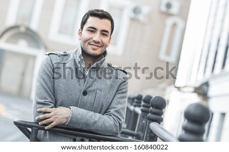 Portrait od smiling gorgeous young attractive man, outdoor - outside coldly morning. Beautiful man wearing coat - winter clothing