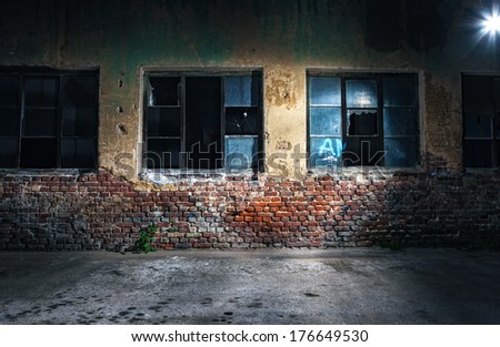 Old cracked or grungy wall and windows at background, night shot