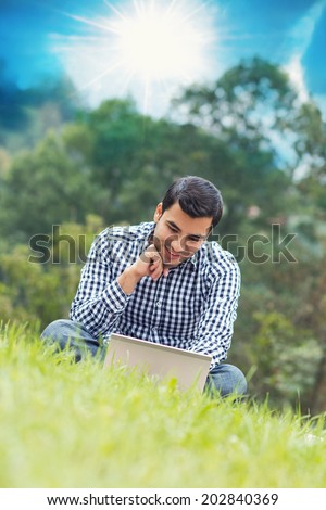 Happy young man with laptop, outdoor - outside