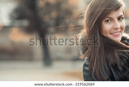 Close up brunette portrait with natural look, head shot of a young sexy woman on blurred background, soft sunny colors. Copyspace