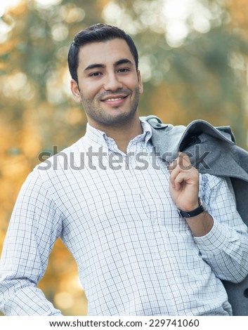Portrait of gorgeous young smile man. Outdoor - outside. Happy turkish guy