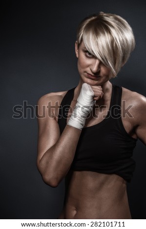 Portrait of boxer woman over dark gray backgroud