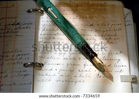 Vintage Fountain Pen and Old Writing in Cookbook Under Dramatic Light