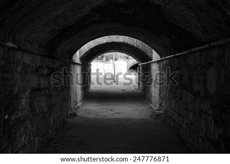 Black and White image of empty dark tunnel